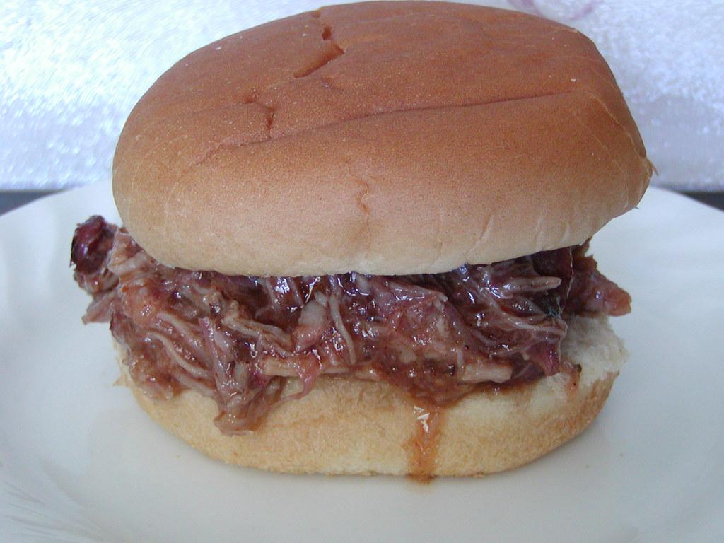 Assembling the Ideal Pulled Pork Sandwich with Toppings